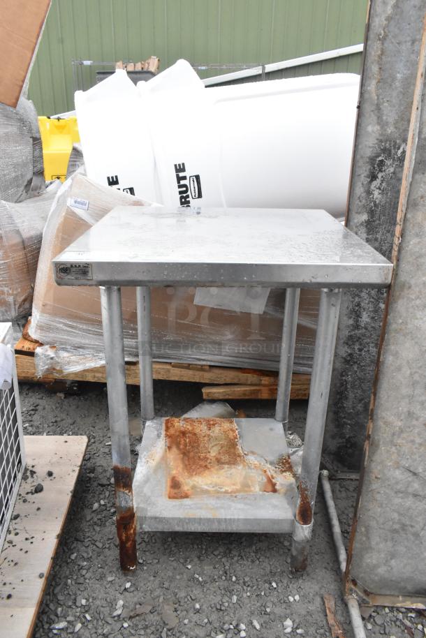 Commercial stainless steel table with under shelf, showing signs of rust and wear. NSF label visible. Ideal for refurbishment.