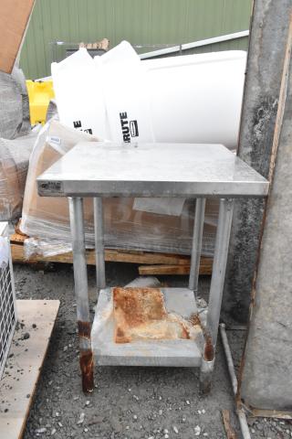 Commercial stainless steel table with under shelf, showing signs of rust and wear. NSF label visible. Ideal for refurbishment.