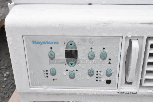 Keystone KSTAW25C window air conditioner, 208/230V, with control panel. Appears in used condition with some water droplets.