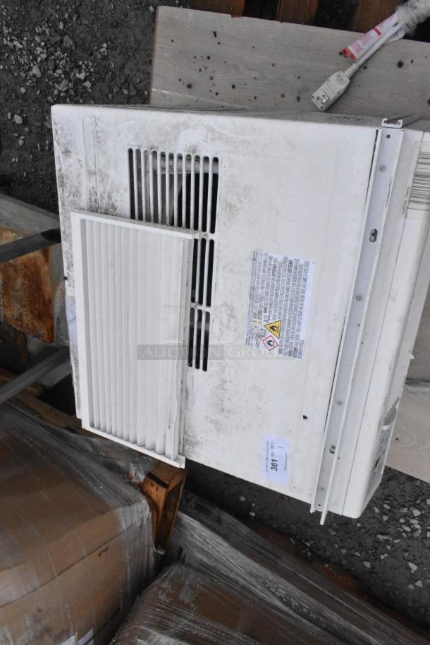 Keystone KSTAW25C window air conditioner, 208/230V, 1 phase. Visible wear; inspection stickers and warning labels present.
