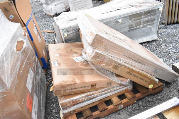 Three brand new outdoor tables in original packaging, marked scratch and dent, on a pallet with visible item number 427CAU32328R.