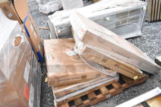 Three brand new outdoor tables in original packaging, marked scratch and dent, on a pallet with visible item number 427CAU32328R.