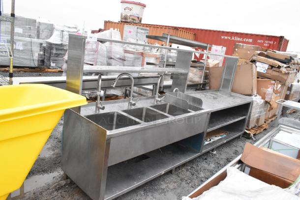 Commercial prep station with 3-bay sink, single hand sink, under shelves, and over shelf, stainless steel, used.
