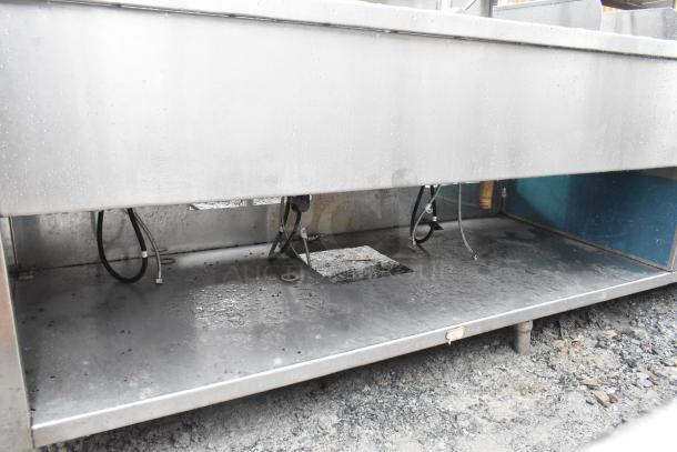 Commercial prep station with 3-bay sink, single bay hand sink, under shelves, and over shelf. Stainless steel. Used condition.