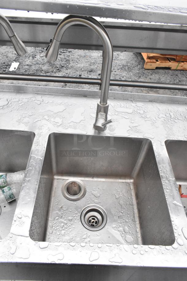 Commercial prep station with three-bay sink, single bay hand sink, under shelves, and over shelf, in used condition.