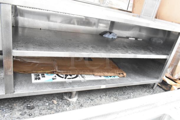 Commercial prep station with three-bay sink, single bay hand sink, under shelves, over shelf. Stainless steel, used condition.