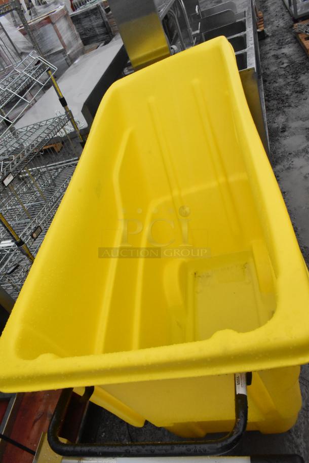 Lavex 475UTT10HNDL yellow poly tilt truck, 1 cubic yard, in good condition. Metal handle visible. Durable construction.