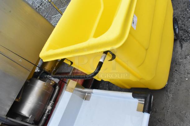 Lavex 475UTT10HNDL yellow poly tilt truck, 1 cubic yard capacity, black handle, on wheels, good condition.