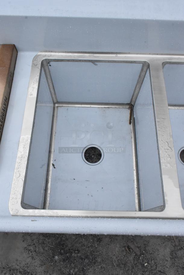 Regency 600S31824218 commercial 3 bay sink, stainless steel, brand new with scratch and dent, visible drain openings.