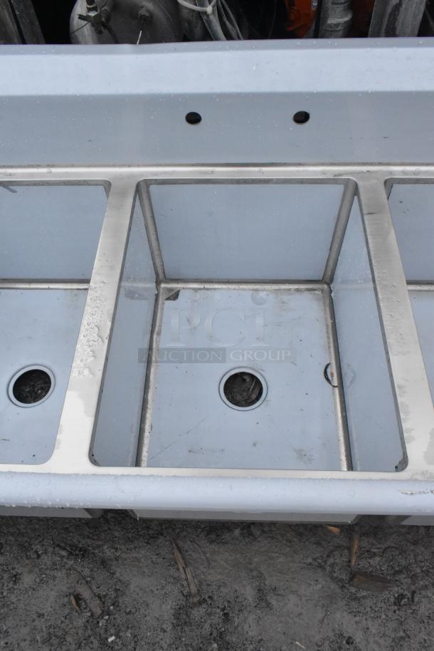 BRAND NEW SCRATCH AND DENT! Regency 600S31824218 commercial 3-bay sink, stainless steel, minor surface dents visible.