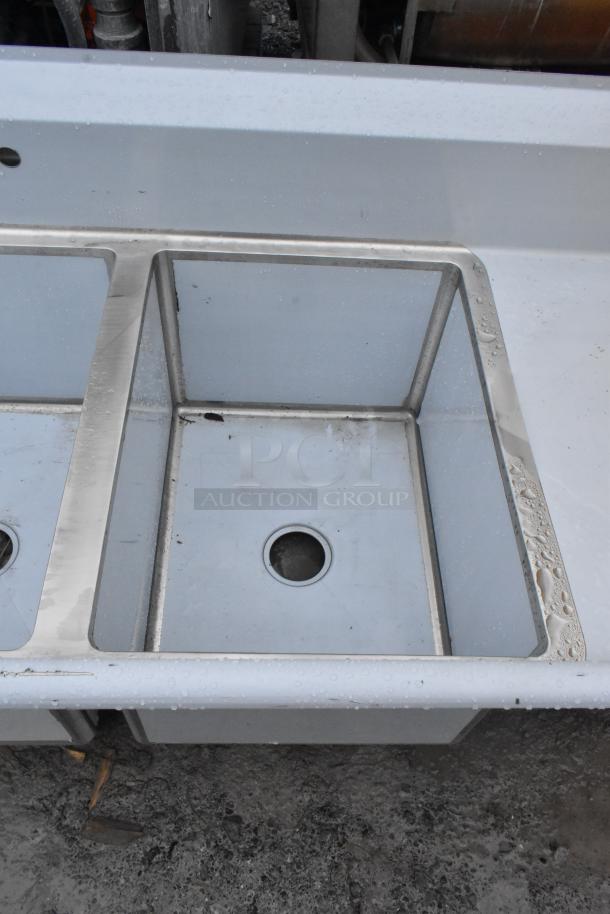 Brand new Regency 600S31824218 commercial 3-bay sink with visible scratches and dents. Stainless steel finish.