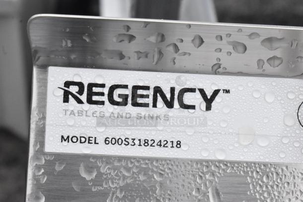 BRAND NEW SCRATCH AND DENT! Regency 600S31824218 Commercial 3 Bay Sink, stainless steel, with visible model label and water droplets.