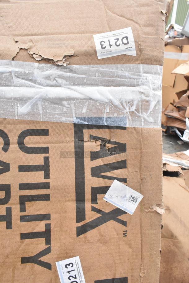 Cardboard packaging for Lavex utility cart, marked with labels showing minor damage. Item inside appears new, 40 3/4" x 25 1/2" x 33 1/2".
