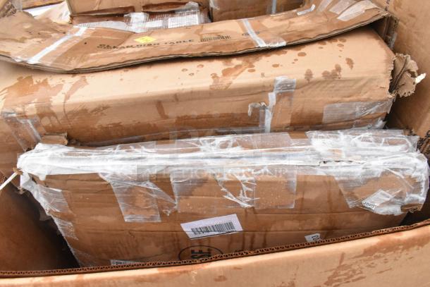 Cardboard boxes containing 10 brand new scratch and dent items, including a sink and work table, in unopened condition.