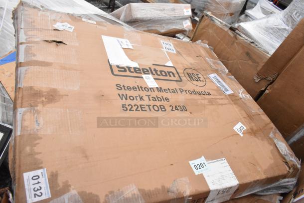 Cardboard box labeled "Steelton Metal Products Work Table 522ETOB 2430." Visible wear, part of a scratch and dent auction.