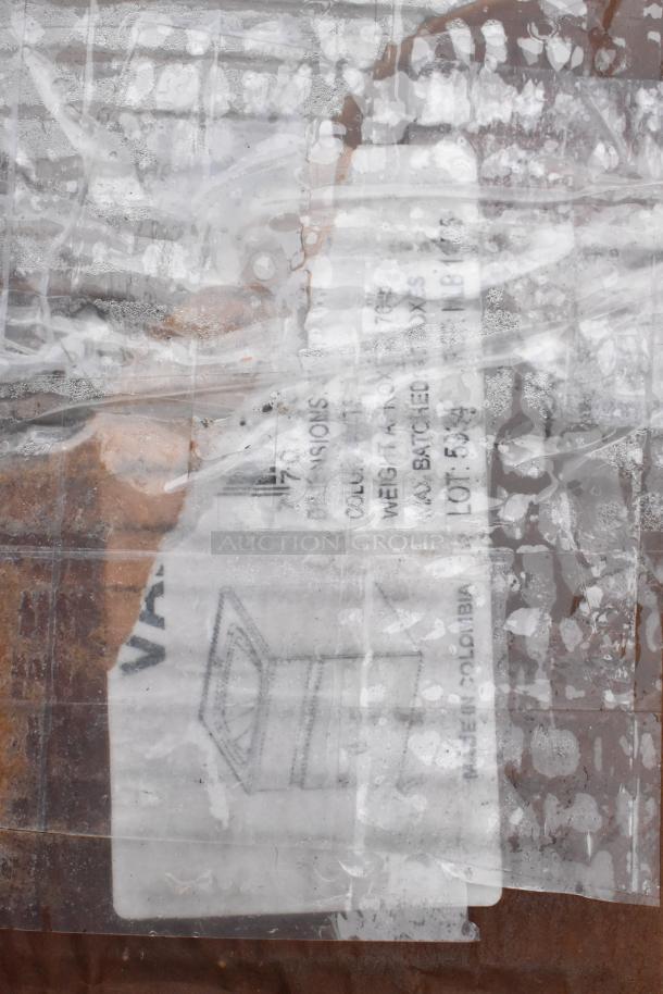 Plastic-wrapped label showing a faded diagram and text on a scratched surface. Details unclear due to wear.