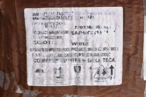 Label on auction item with manufacturing details, mentions product color as white and compliance with safety regulations.