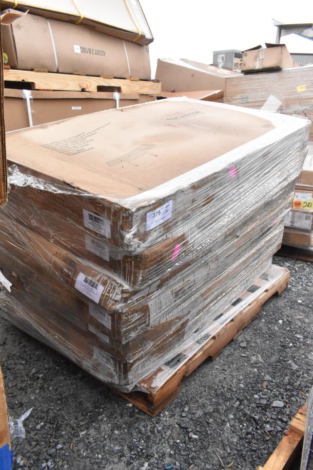 Stack of brand new scratch-and-dent items, wrapped on pallets. Includes outdoor tables. Labels show lot number 375.