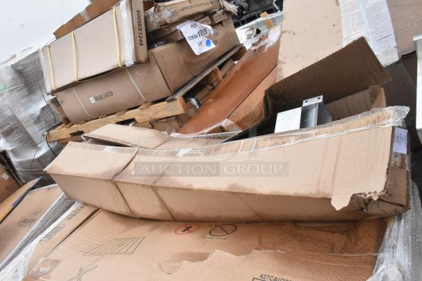 15 new scratch and dent boxed items, including outdoor tables. Boxes show wear, some damage visible.