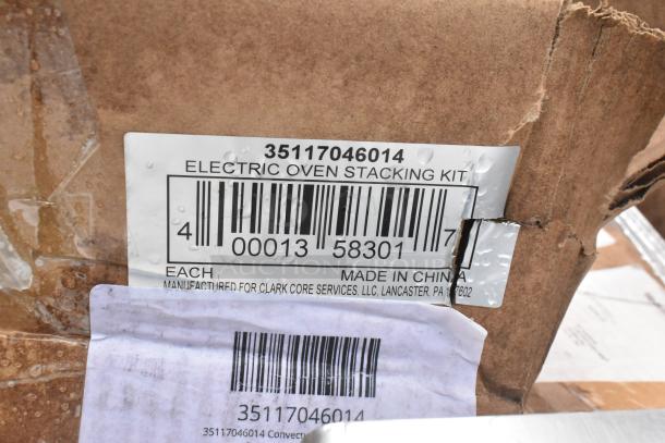 Damaged box with Electric Oven Stacking Kit label, barcode 35117046014, made in China for Clark Core Services.