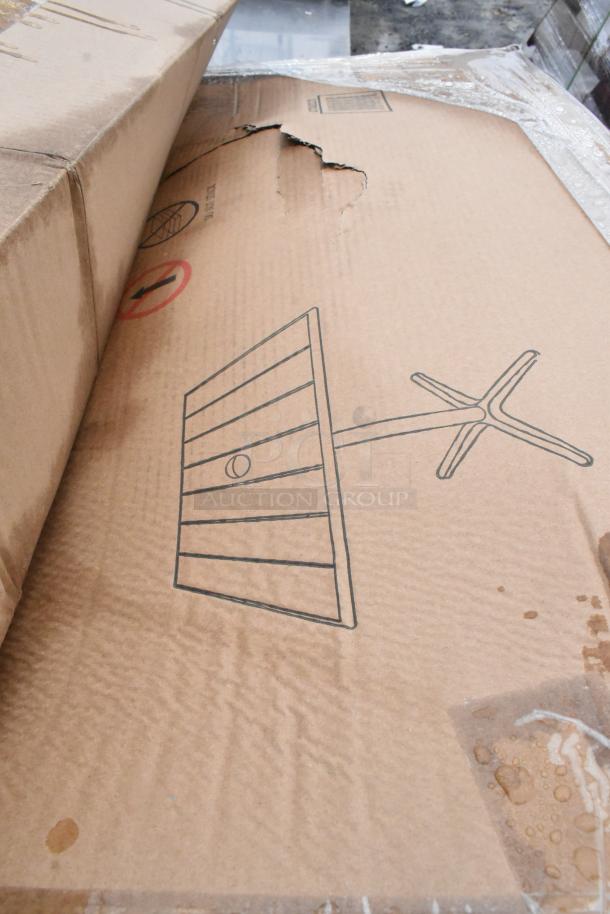Cardboard box with a tear, showing diagram of an outdoor table. Labeled "15 Brand New Scratch and Dent" items inside.