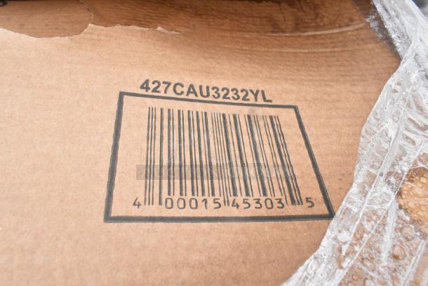 Cardboard with barcode labeled "427CAU3232YL" indicating scratch and dent items, wrapped in protective material.
