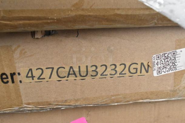 Cardboard box showing label "427CAU3232GN," minor scratches and dents. Contains assorted outdoor items.