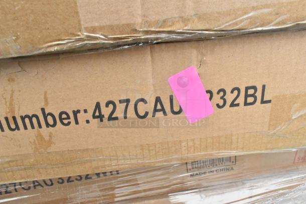 Cardboard boxes labeled "427CAU232BL," marked with a pink sticker. Packaging shows minor wear. Items include outdoor tables.