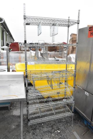 Chrome 7-tier wire shelving unit, sturdy construction, slight wear. Buyer must dismantle. Ideal for storage solutions.