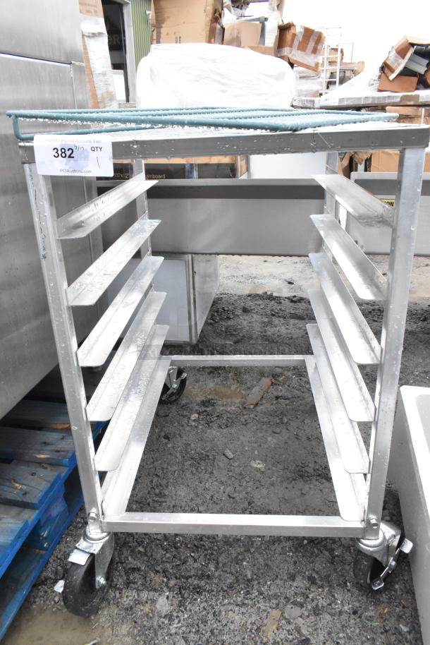 Commercial pan transport rack on casters, metal construction, ten shelves, label indicates auction ID "382", used condition.