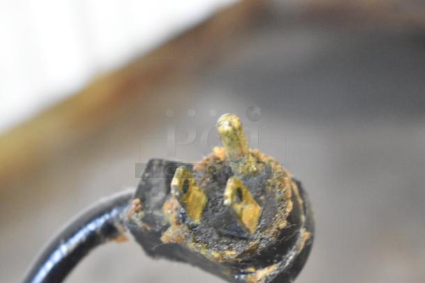 Close-up of damaged power plug from 2017 Delfield F2936CP Chef Base, showing corrosion and discoloration on the prongs.