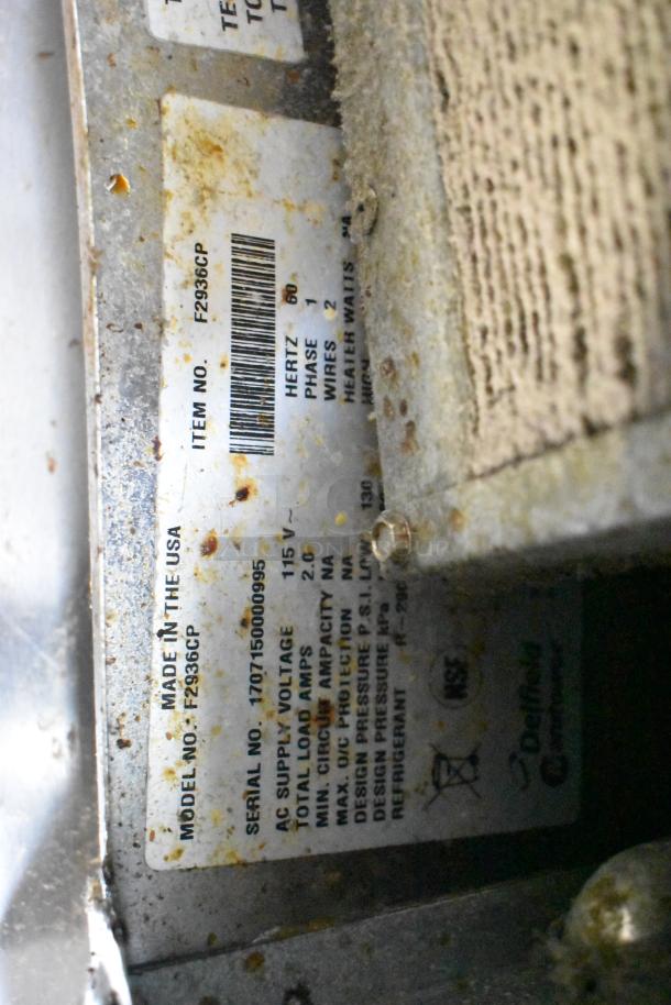 2017 Delfield F2936CP 2-drawer chef base tag; shows specs, model, and serial info; visible wear and markings.