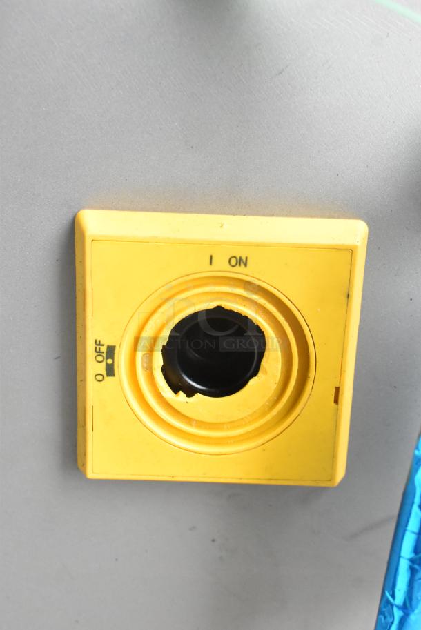Yellow on/off switch of Pro-Cut KS-120 Commercial Vertical Band Meat Saw.