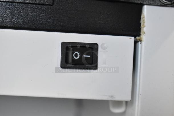 Close-up of a black on/off switch on a 2019 Habco SE18 Commercial Single Door Reach-In Cooler Merchandiser.