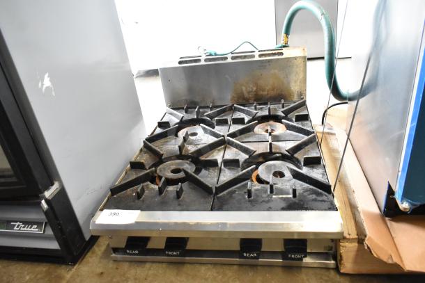 BT60-4N Commercial Gas 4 Burner Range, model BT60-4N, showing some wear with visible labels on control knobs.