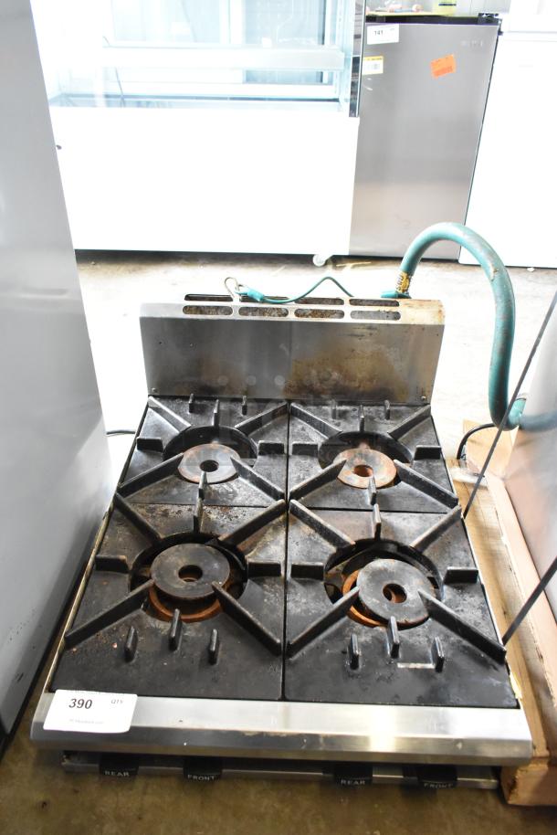 BT60-4N commercial countertop gas range, 4 burners, used condition, visible wear, numbered 390, features durable cast-iron grates.