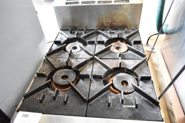 BT60-4N Commercial 4 Burner Gas Range. Used condition with visible wear. Sturdy cast iron grates. Model: BT60-4N.