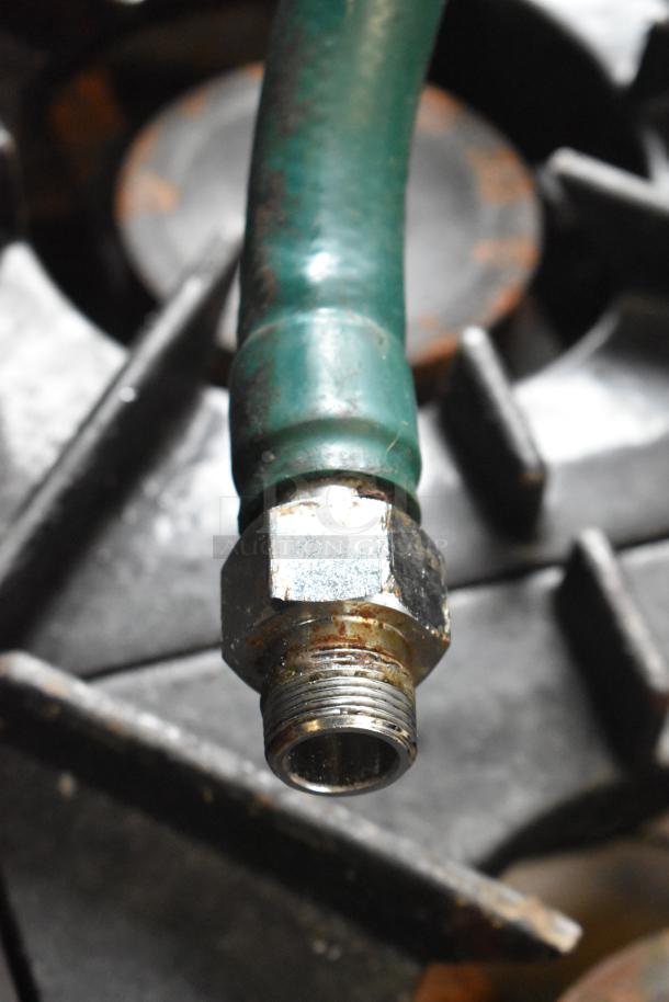 BT60-4N Commercial Gas 4 Burner Range, model BT60-4N, showing gas connector. Slight wear visible.