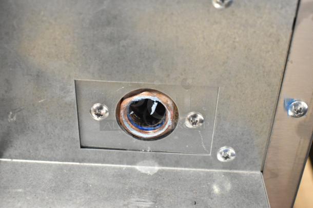 Close-up of 2024 Hoshizaki AM-50BAJ-DS icemaker connection port. Stainless steel surface with visible mounting screws.