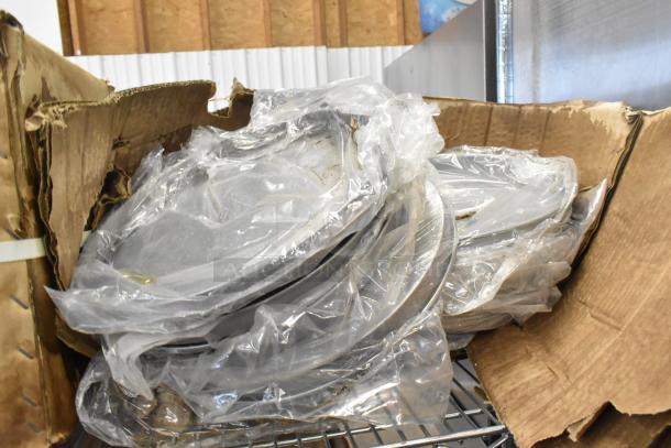 Three brand new boxes of NSP-12 non-stick pizza pans in original packaging, slightly damaged box.