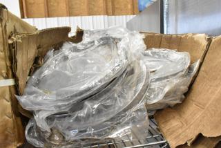 Three brand new boxes of NSP-12 non-stick pizza pans in original packaging, slightly damaged box.