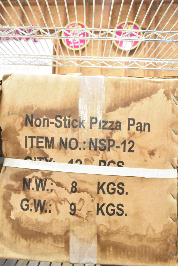 3 new boxes of NSP-12 non-stick pizza pans, each containing 12 pieces. Total weight 9 kg. Visible item details on box.