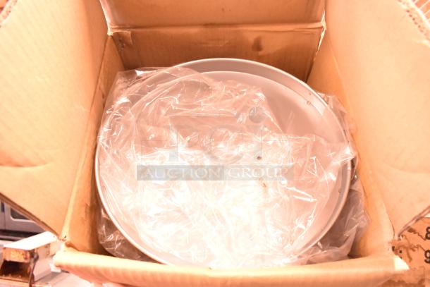 Three brand new boxes of NSP-12 non-stick pizza pans in original packaging.