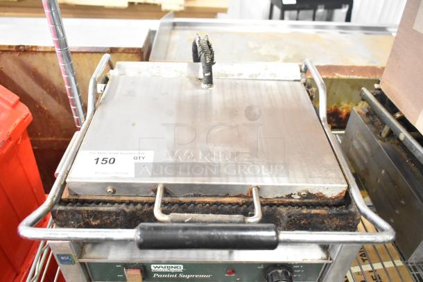 Waring WPG250 countertop panini press, 120 volts, 1 phase. Shows wear, branding visible on the lid. Auction tag "150".