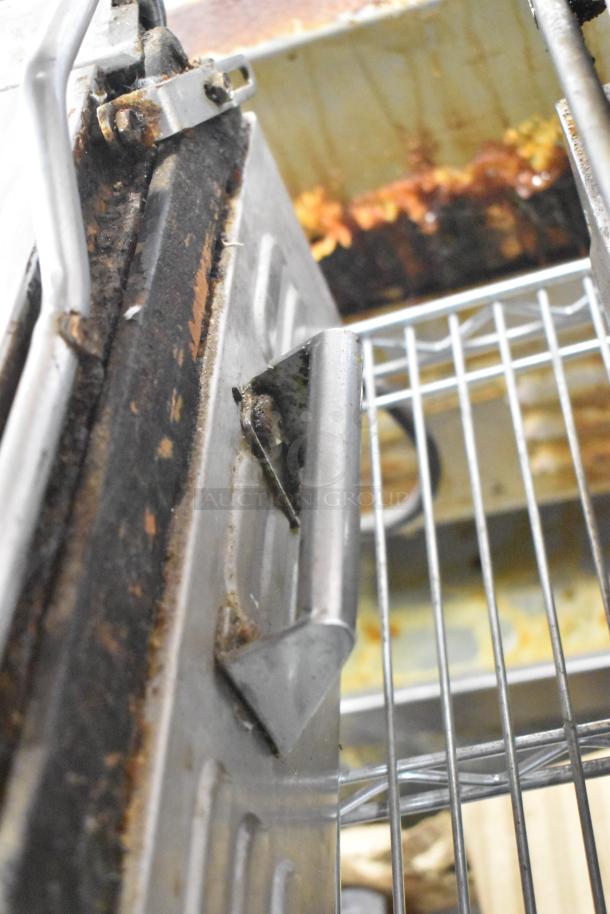 Waring WPG250 countertop panini press in used condition, showing wear and visible rust on the handle and grill area.