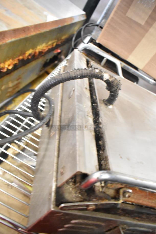 Waring WPG250 Countertop Panini Press, 120 Volts, 1 Phase. Visible rust and wear on exterior, suggesting used condition.