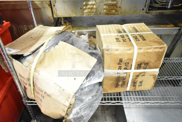 Two boxes of NSP-12 non-stick pizza pans, unopened. Each box labeled with item details and weights.