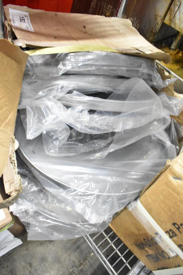 Two new boxes of NSP-12 non-stick pizza pans, wrapped in plastic, in original packaging. Multiple pans visible.