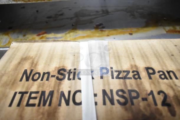 Two unopened boxes of NSP-12 non-stick pizza pans, brand new condition, with visible label and item number.