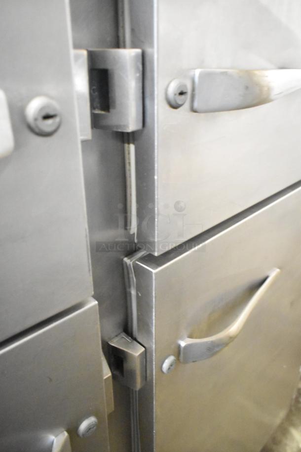 Traulsen Commercial 4 Half Size Door Reach In with casters, stainless steel, prominent door handles, visible hinges.